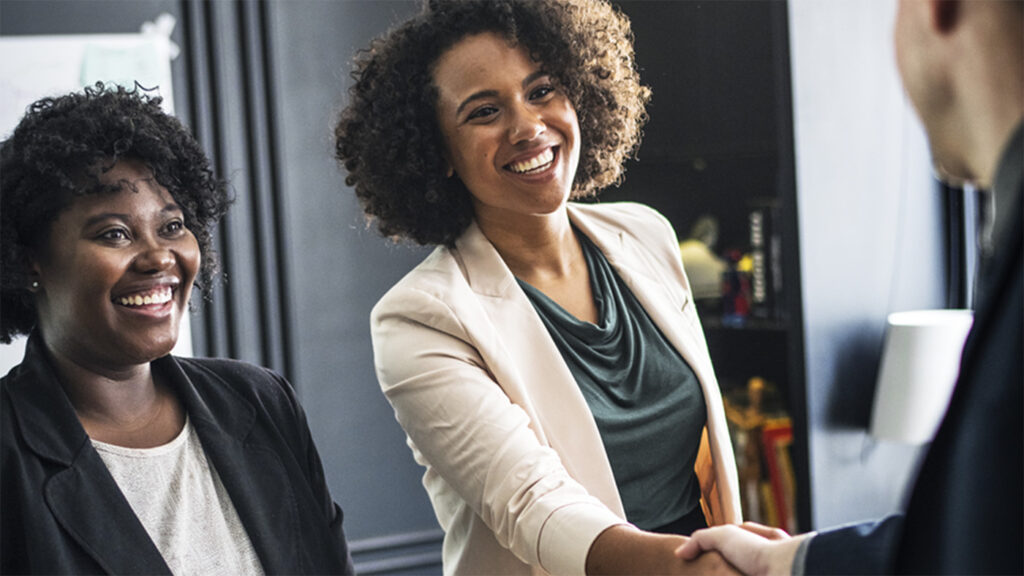 Women in an office shaking hands