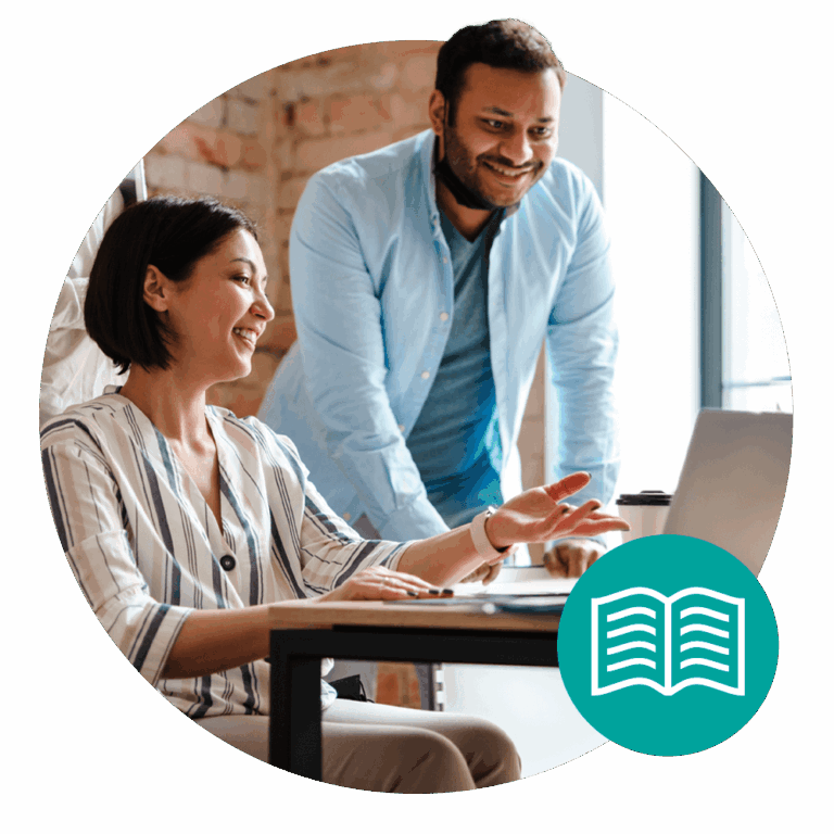 two people sitting at laptop talking