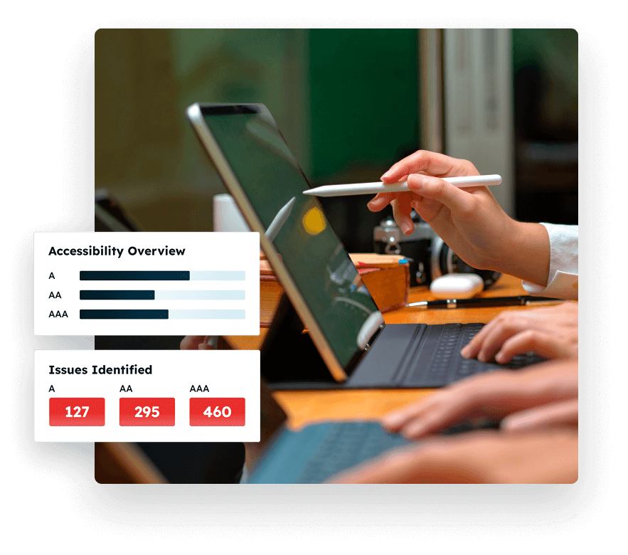 Hands working on a tablet with a keyboard while another person points at the screen with a stylus. On-screen graphics display accessibility overview bars for levels A, AA, and AAA, along with an issues identified chart showing A (127), AA (295), and AAA (460).