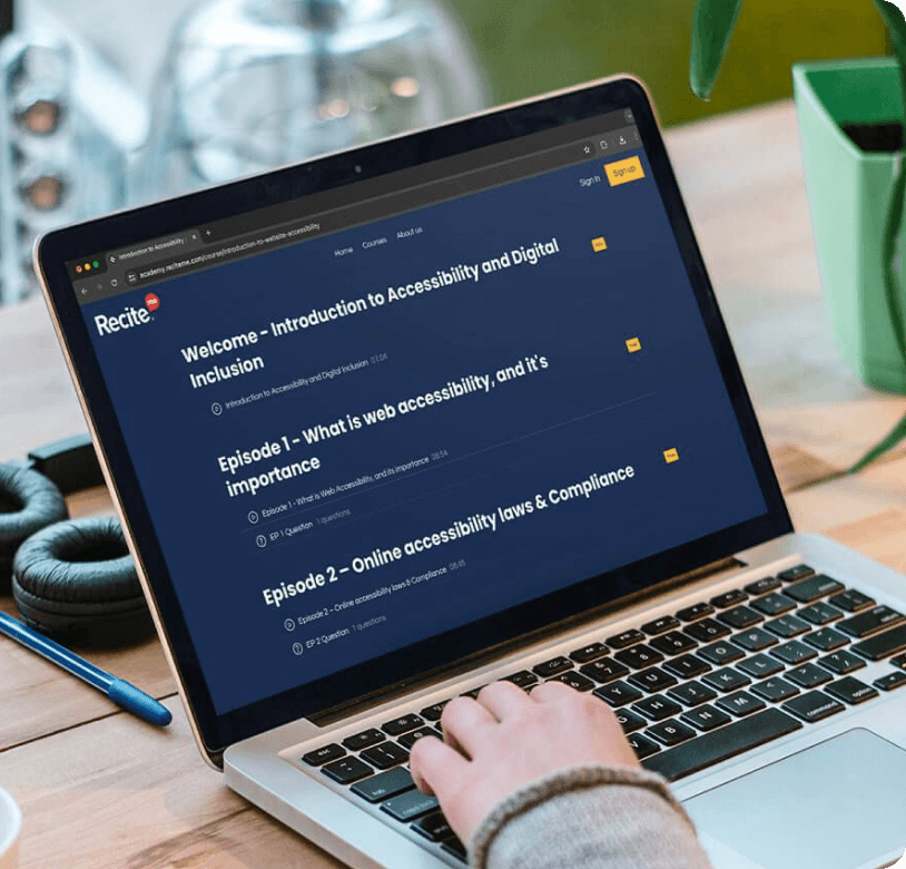 Person using a laptop that displays an online course platform. The screen shows Recite’s Inside Accessibility Academy with a course titled 'Welcome – Introduction to Accessibility and Digital Inclusion' and episodes on web accessibility, its importance, and online accessibility laws and compliance.